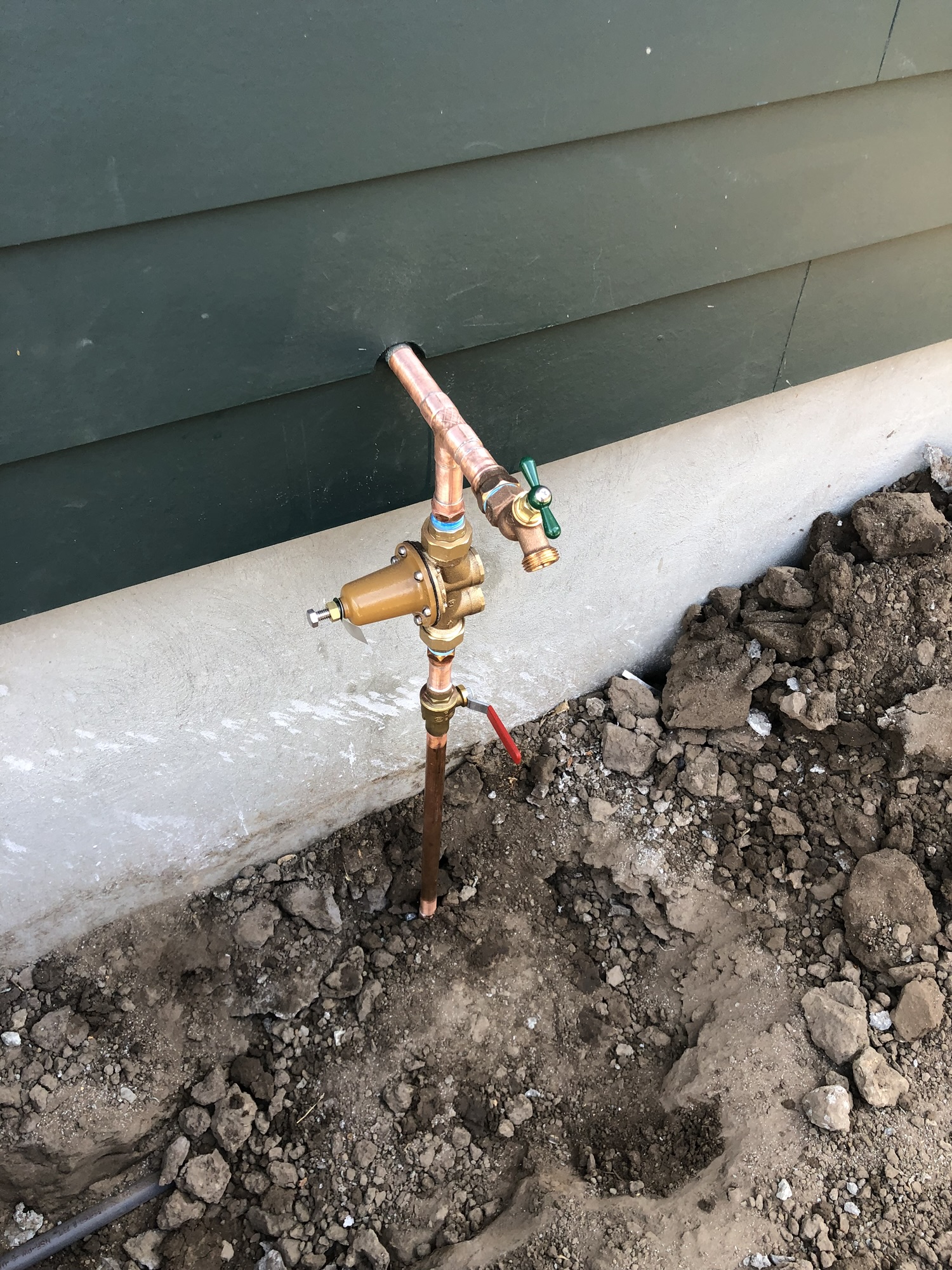 Plumber installing a tankless water heater in a Santa Cruz County home.