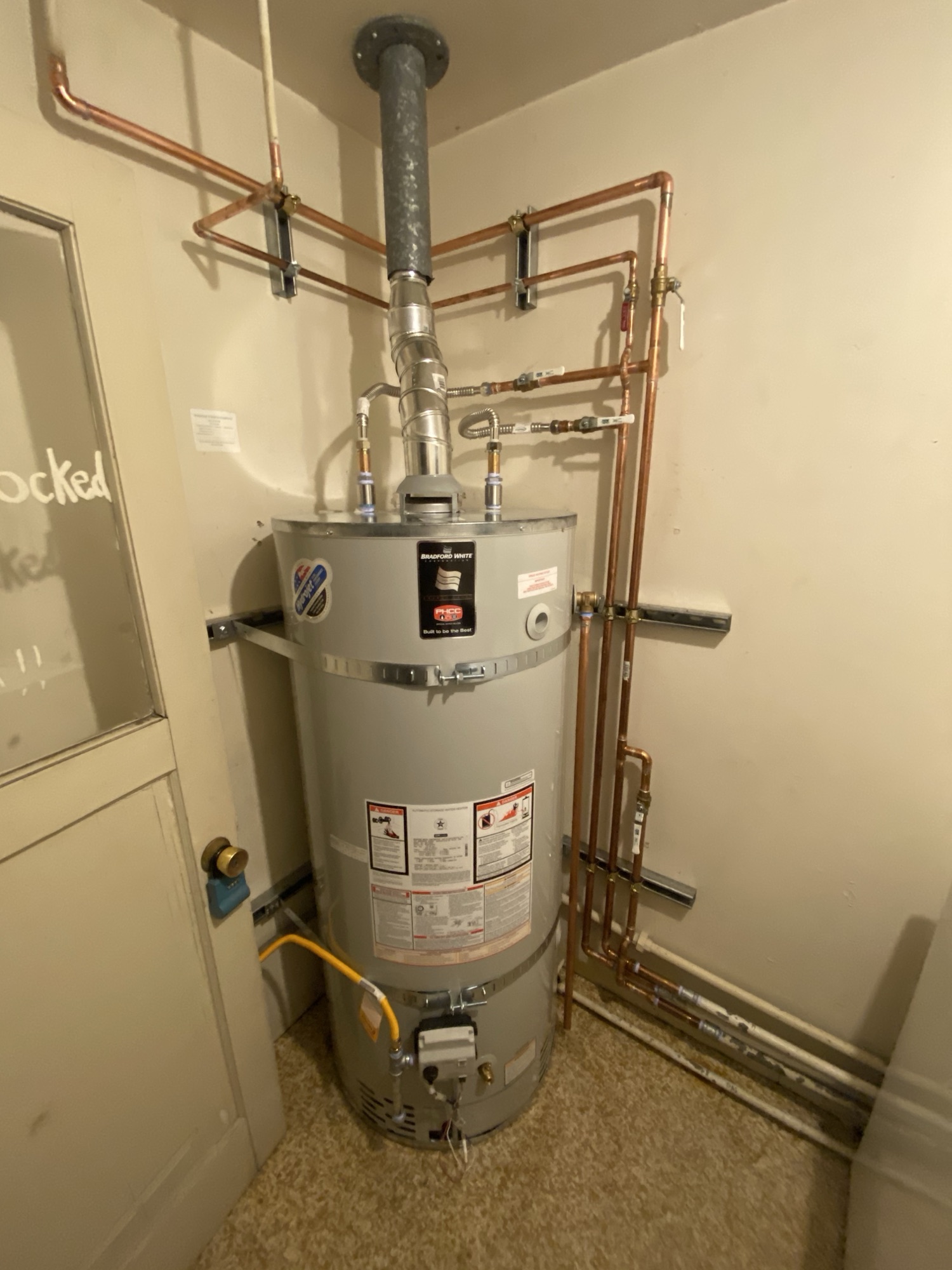 Plumber repairing a residential water line in Santa Cruz County, California, with tools and pipes visible in the background.