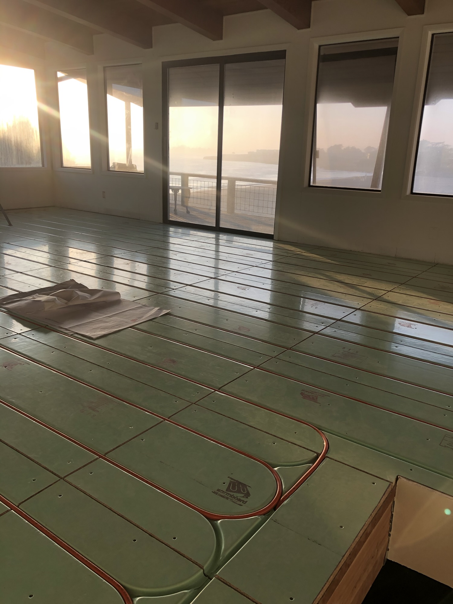 Plumber installing a tankless water heater in a Santa Cruz County home, showcasing professional plumbing services.